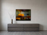 Yellow Delicacy by Frantisek Strouhal: a yellow daisy in front of rusted mottled metal in dark orange tones, the 32 by 24 inch print in a black painted floater frame, hanging above a smoked ash sideboard in a calm room, shown at its true size