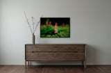 Lupins by Frantisek Strouhal: pink and coral lupin spikes above green leaves, dark background, the 33 by 22 inch print in a black painted floater frame, hanging above a smoked ash sideboard in a calm room, shown at its true size