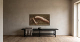 Contour 2 by Frantisek Strouhal: a reclining nude body arched in profile, warm sepia and brown, the 40 by 20 inch print in a dark oak floater frame, hanging above a black painted bench in a calm room, shown at its true size