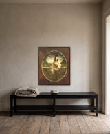 Serene in Nature by Frantisek Strouhal: woman kneeling by a pond, draped cloth, oval vignette on dark brown, the 24 by 30 inch print in a dark oak floater frame, hanging above a black painted bench in a calm room, shown at its true size