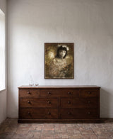 Hannah and the Butterfly by Frantisek Strouhal: a girl with dark bobbed hair holds a butterfly on her hand, the 24 by 30 inch print in a dark oak floater frame, hanging above a low chest of drawers in a calm room, shown at its true size