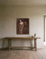 Musing by the Candle Light by Frantisek Strouhal: woman in an off-shoulder gown by a candlelit stone pedestal, the 24 by 30 inch print in a dark oak floater frame, hanging above a elm console in a calm room, shown at its true size