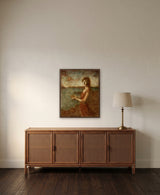 Living a Fairy Tale by Frantisek Strouhal: woman in a rust dress by the sea holding a butterfly, the 24 by 30 inch print in a dark oak floater frame, hanging above a rattan and wood sideboard in a calm room, shown at its true size