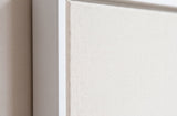 The corner of the white painted floater frame, with the shadow gap that runs all the way round between the canvas and the wood.