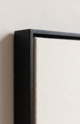 The corner of the black painted floater frame, with the shadow gap that runs all the way round between the canvas and the wood.