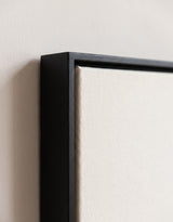 The corner of the black painted floater frame, with the shadow gap that runs all the way round between the canvas and the wood.