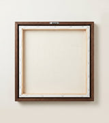 The back of the framed canvas: the canvas stretched over light wooden bars and stapled around the inner edge, one sawtooth hanger fitted to the top bar, and no bracing across the middle. The frame edge is dark oak.