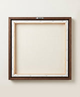 The back of the framed canvas: the canvas stretched over light wooden bars and stapled around the inner edge, one sawtooth hanger fitted to the top bar, and no bracing across the middle. The frame edge is dark oak.