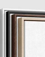 The four frames it comes in, nested one inside another so the wood and the profile of each can be seen: white on the outside, then black, then dark oak, then oak. Each holds a blank canvas, with the shadow gap that runs between the canvas and the wood.