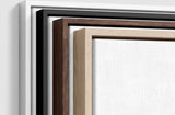 The four frames it comes in, nested one inside another so the wood and the profile of each can be seen: white on the outside, then black, then dark oak, then oak. Each holds a blank canvas, with the shadow gap that runs between the canvas and the wood.