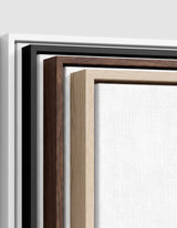 The four frames it comes in, nested one inside another so the wood and the profile of each can be seen: white on the outside, then black, then dark oak, then oak. Each holds a blank canvas, with the shadow gap that runs between the canvas and the wood.
