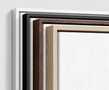 The four frames it comes in, nested one inside another so the wood and the profile of each can be seen: white on the outside, then black, then dark oak, then oak. Each holds a blank canvas, with the shadow gap that runs between the canvas and the wood.