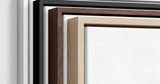 The four frames it comes in, nested one inside another so the wood and the profile of each can be seen: white on the outside, then black, then dark oak, then oak. Each holds a blank canvas, with the shadow gap that runs between the canvas and the wood.