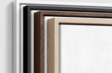 The four frames it comes in, nested one inside another so the wood and the profile of each can be seen: white on the outside, then black, then dark oak, then oak. Each holds a blank canvas, with the shadow gap that runs between the canvas and the wood.