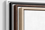 The four frames it comes in, nested one inside another so the wood and the profile of each can be seen: white on the outside, then black, then dark oak, then oak. Each holds a blank canvas, with the shadow gap that runs between the canvas and the wood.
