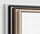 The four frames it comes in, nested one inside another so the wood and the profile of each can be seen: white on the outside, then black, then dark oak, then oak. Each holds a blank canvas, with the shadow gap that runs between the canvas and the wood.